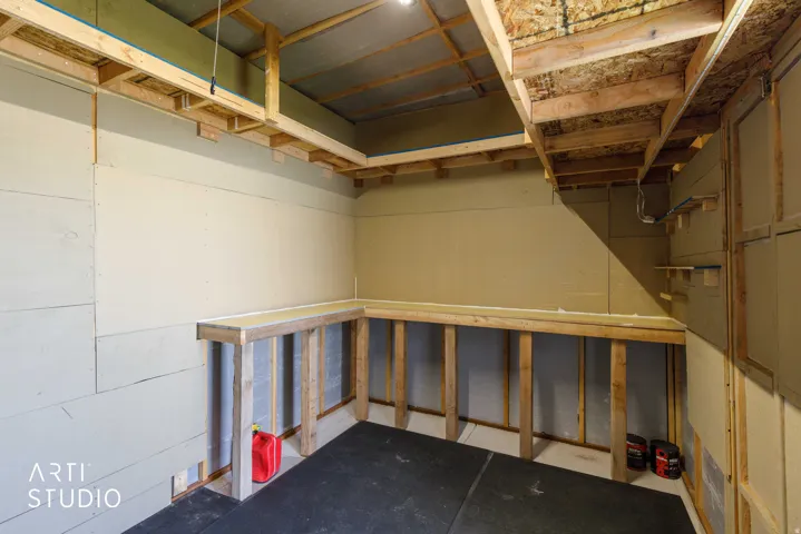 Storage shed showing electric lighting and built in work bench.