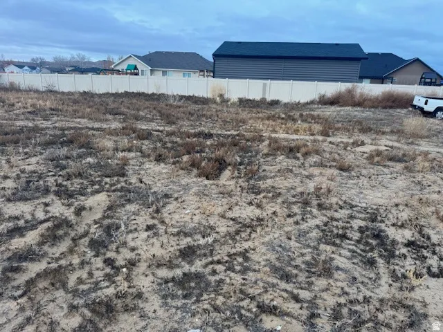 Expansive parcel featuring a perimeter fence and varied ground cover