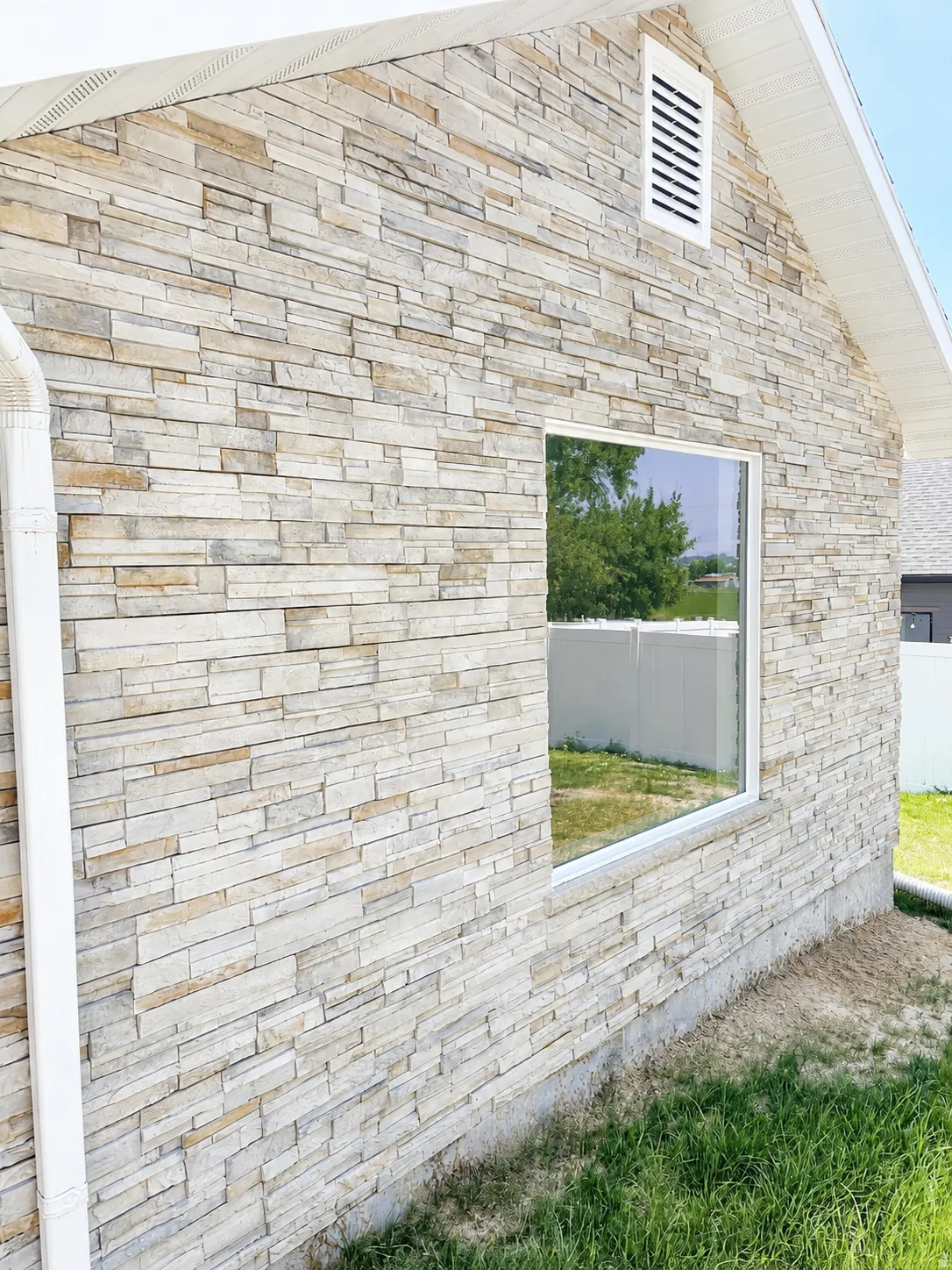 Stone veneer exterior with white soffit and fascia