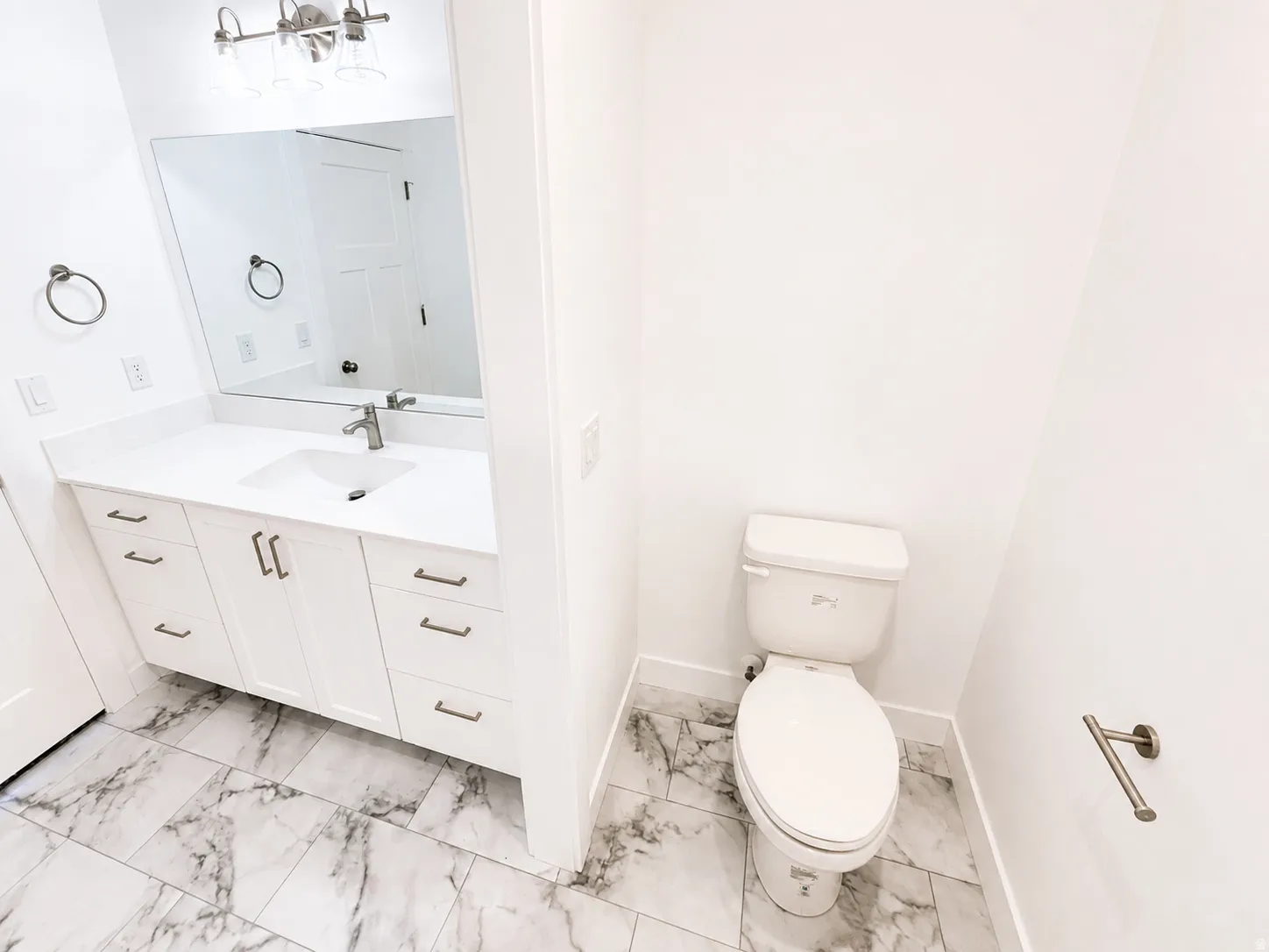 Master bathroom featuring a white vanity with brushed nickel hardware, a rectangular undermount sink, and a large wall-mounted mirror