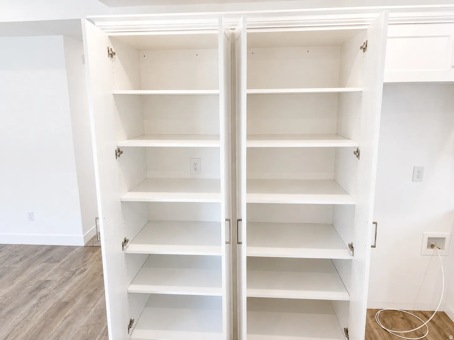 Built-in white cabinetry with adjustable shelving