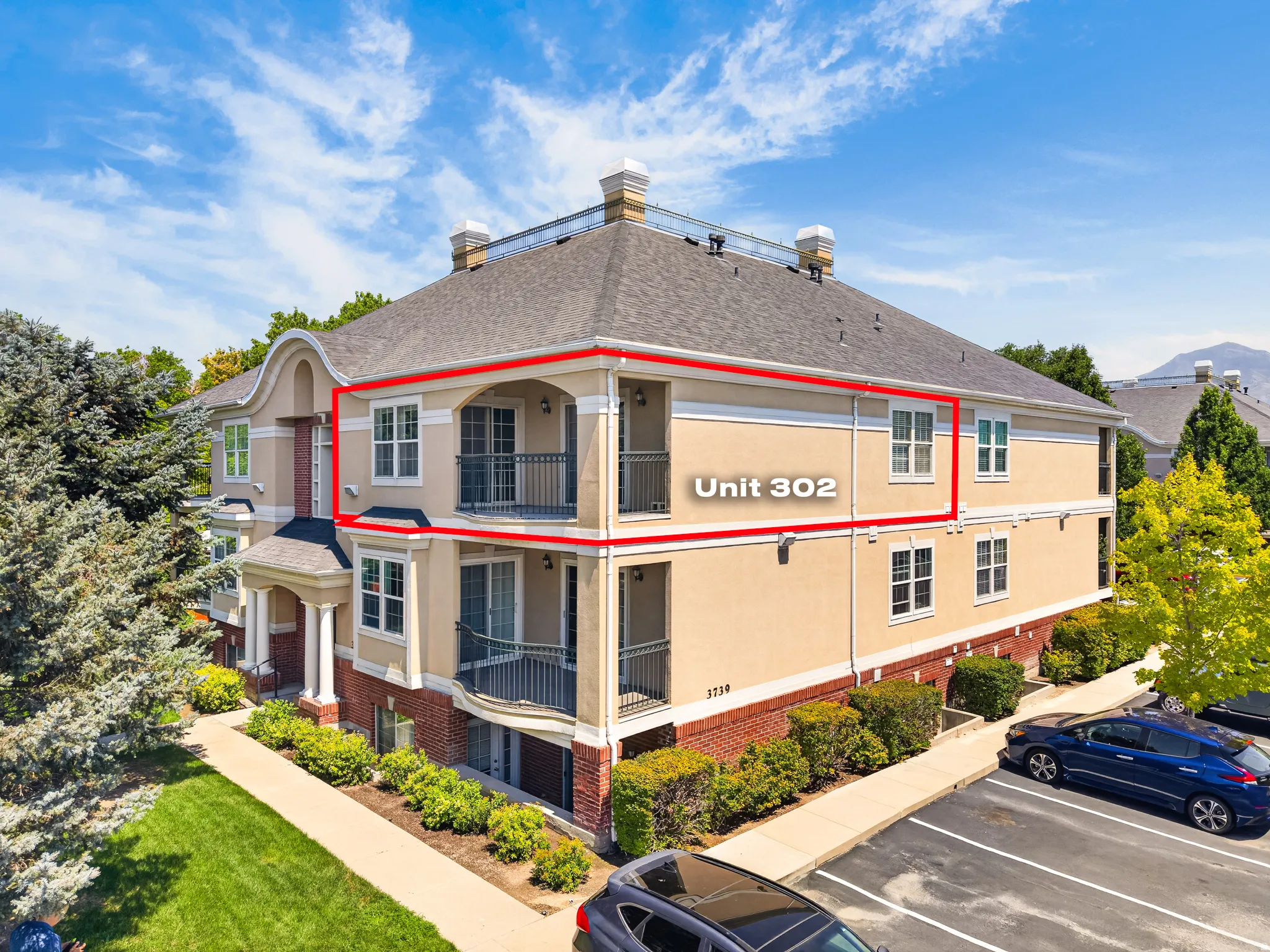 Multi-story building featuring a stucco exterior with brick accents and multiple balconies