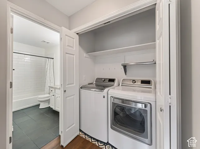 Convenient laundry closet with built-in shelving, hanging rod, and appliances