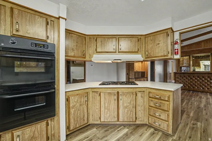Kitchen featuring wood-finish cabinetry, white countertops, and a built-in gas cooktop