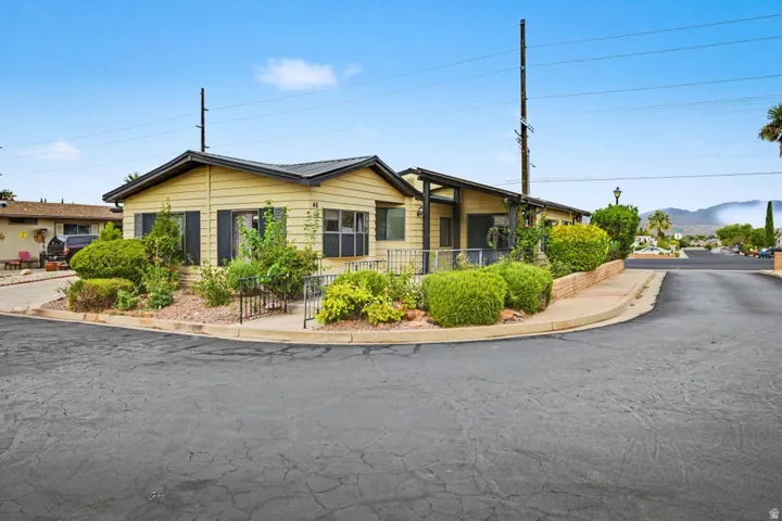 Light yellow-sided residence with dark trim and a gabled roof
