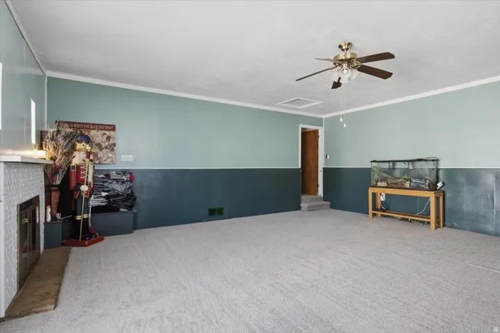 Spacious room featuring carpeting, two-tone wall paint, and white trim