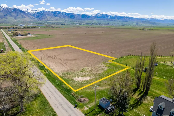 Expansive land parcel featuring clear, flat terrain and distant mountain scenery