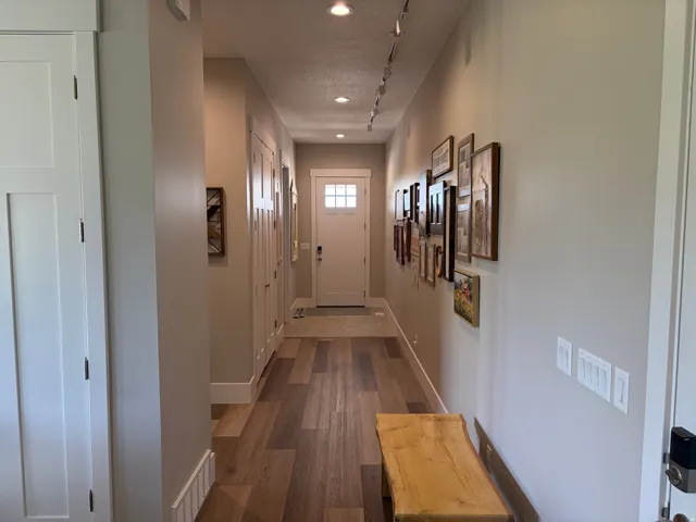 Entryway featuring wood-finish flooring, recessed lighting, and a paneled front door with lites