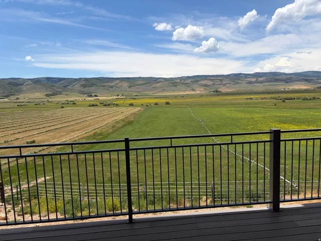 Outdoor deck featuring composite decking and a black metal railing