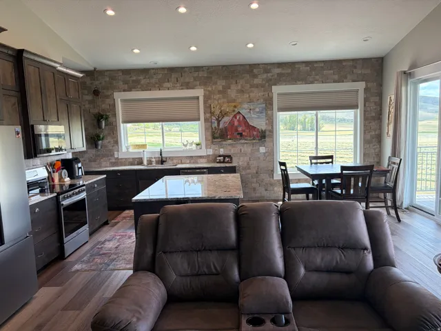 Open-concept kitchen and dining area with wood-finish flooring