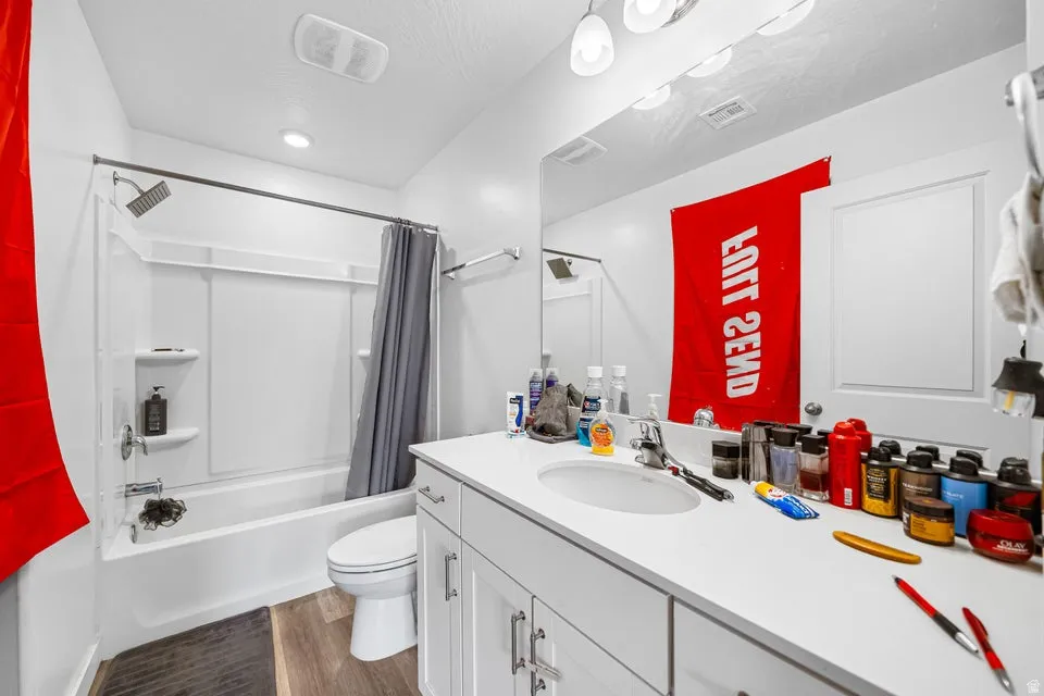 Bathroom featuring a white vanity with an integrated sink, white countertop, and contemporary cabinetry