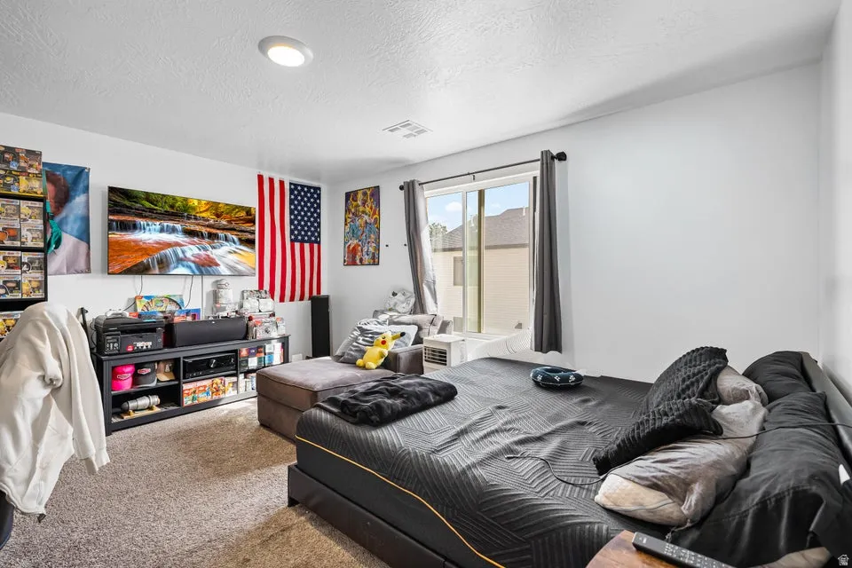 Carpeted interior space featuring a window, recessed ceiling lighting, and white walls