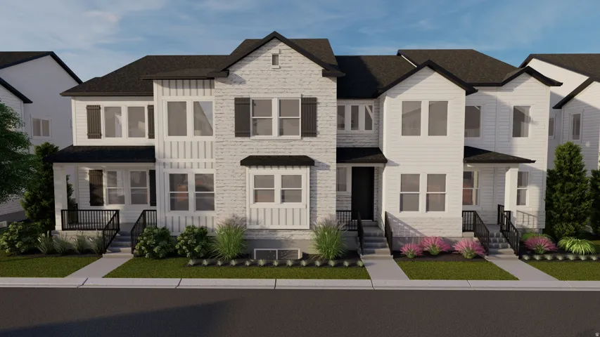Modern townhome exterior featuring a white facade, black accents, multiple windows, dark roofline, and landscaped front entryways