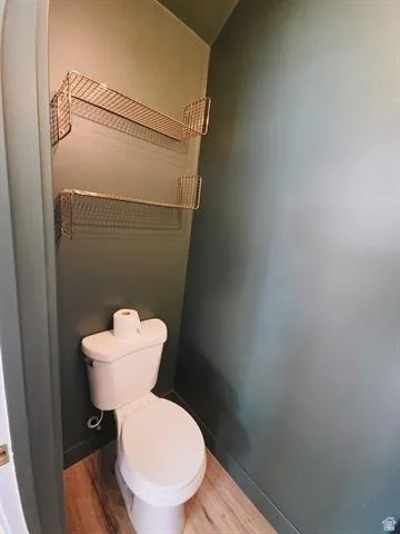 Compact water closet featuring a standard white toilet
