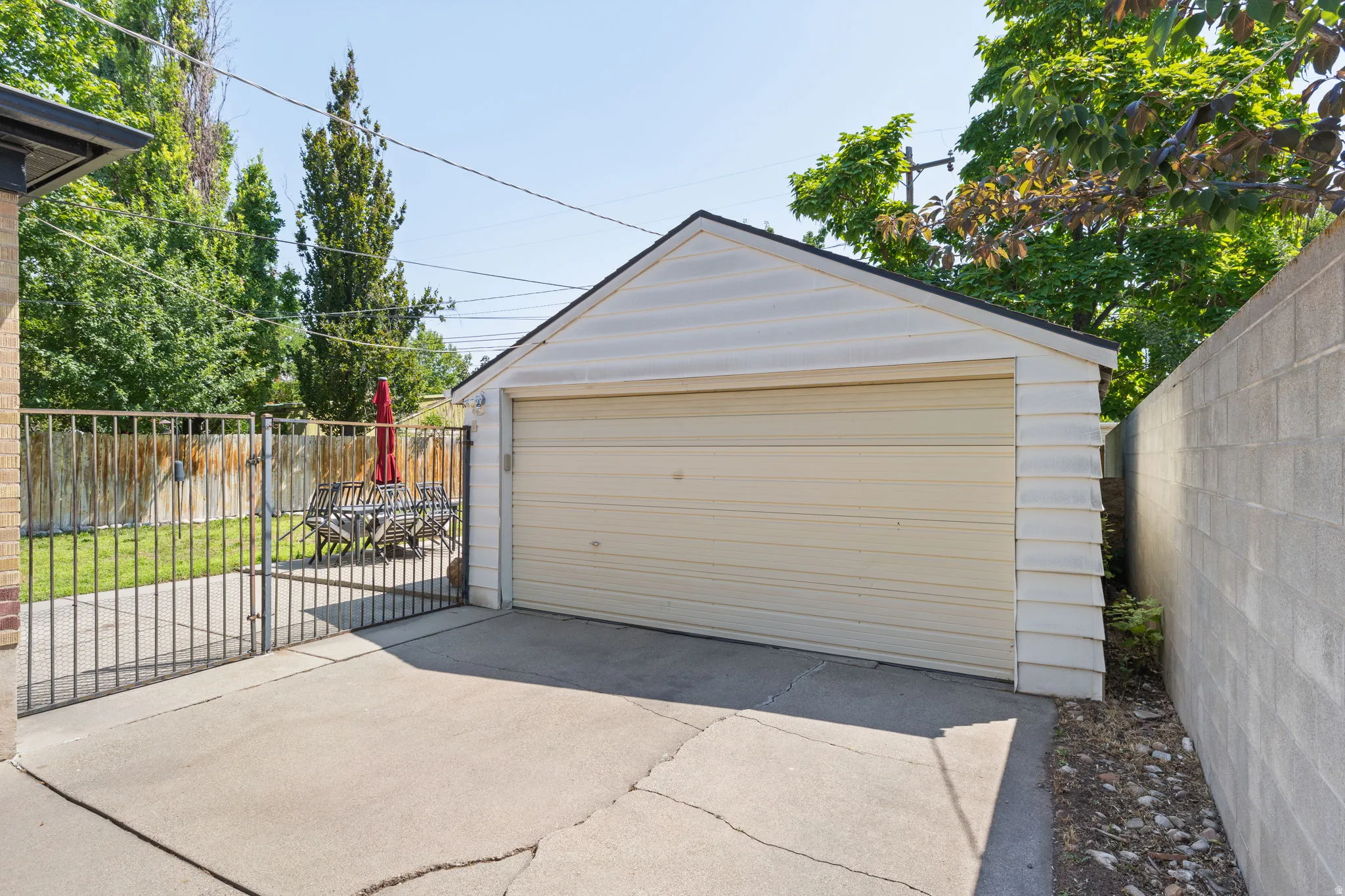 Detached garage featuring horizontal siding and an overhead door