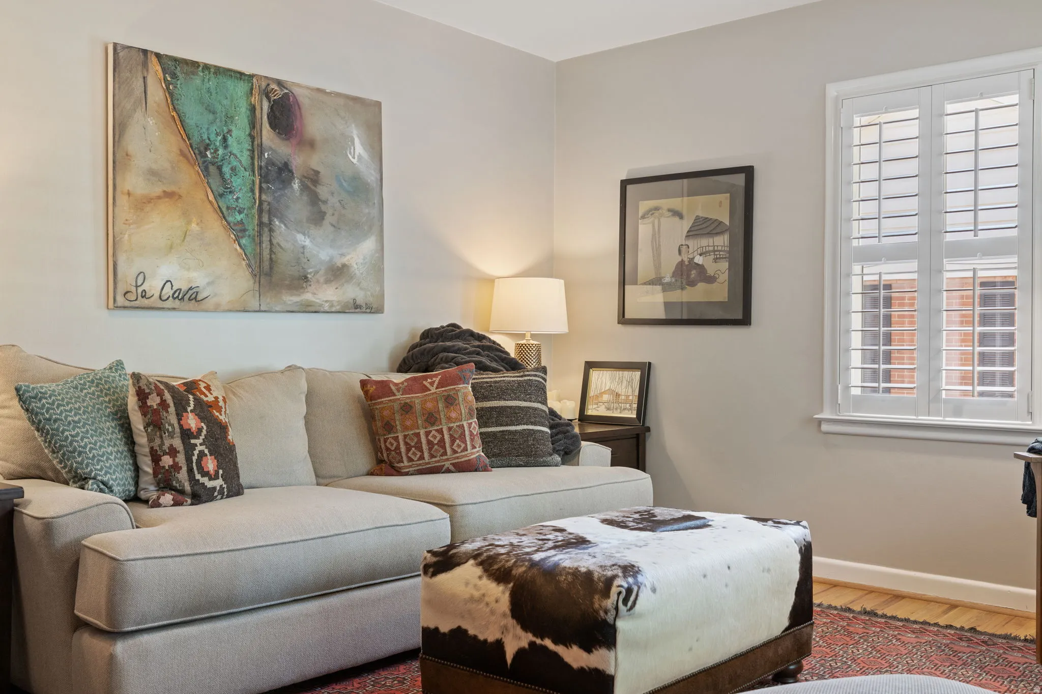 Neutral wall tones complement the wood-finish flooring