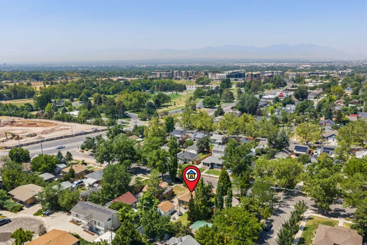 Aerial view showcasing this residential property nestled within a tree-lined neighborhood