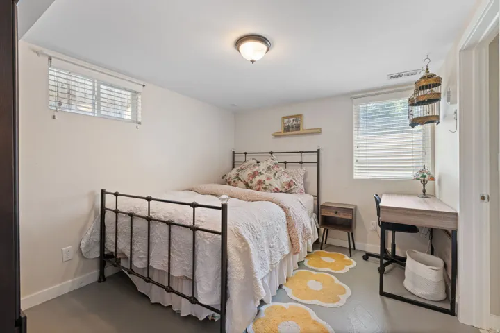White painted walls with two windows featuring horizontal blinds, recessed lighting, and a neutral-toned ceiling