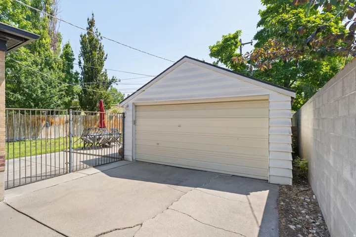 Detached garage featuring horizontal siding and an overhead door