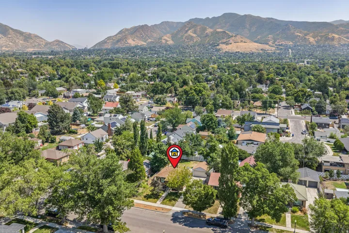 Lush, tree-lined neighborhood situated against a backdrop of distant mountains