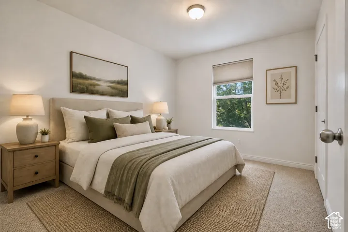 Bedroom featuring a window with a roller shade, carpeted flooring, and a flush mount ceiling light fixture