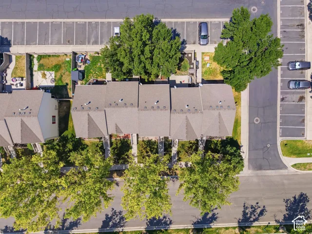 Aerial view of contemporary townhome community featuring multiple units with pitched rooflines, mature landscaping throughout the grounds, and organized parking areas