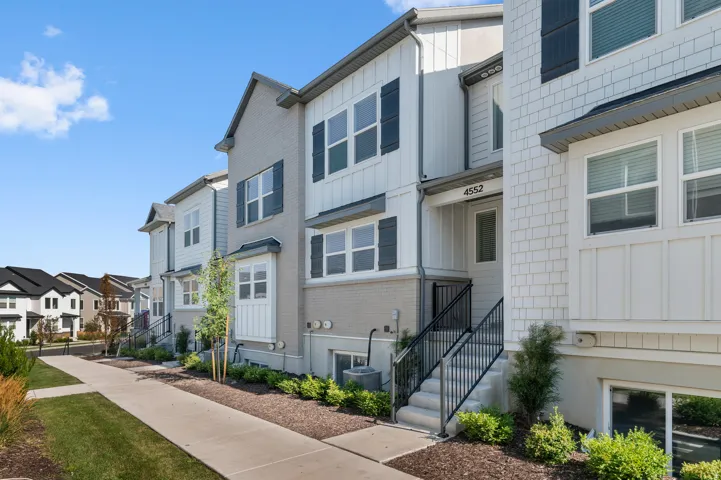 Modern townhome exterior featuring shingle and board-and-batten siding