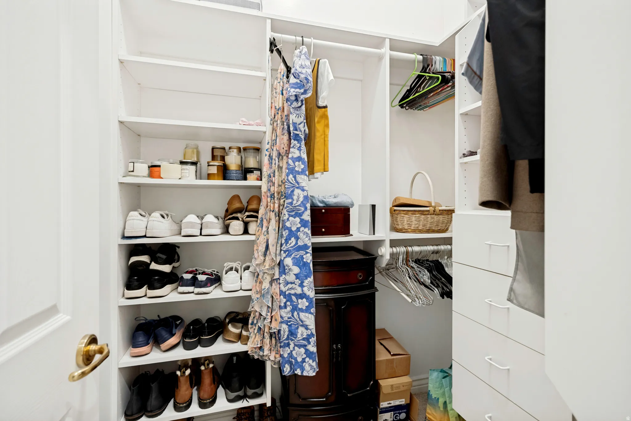 Custom closet system featuring multiple shelving units, hanging rods, and integrated drawers