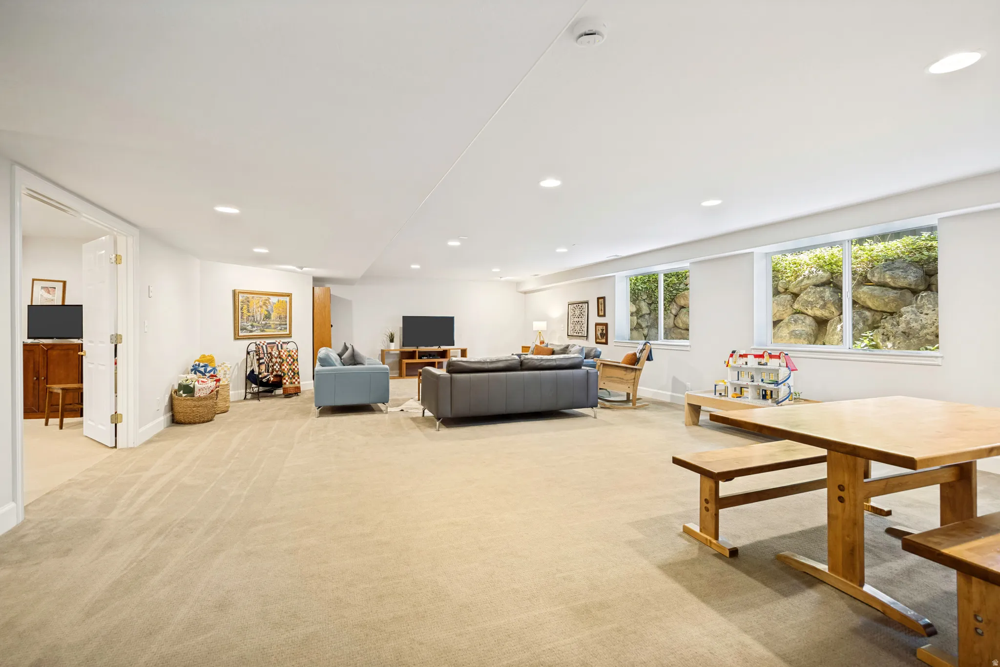 Expansive recreation room featuring carpet, recessed ceiling lighting, and abundant natural light