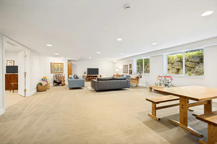 Expansive recreation room featuring carpet, recessed ceiling lighting, and abundant natural light