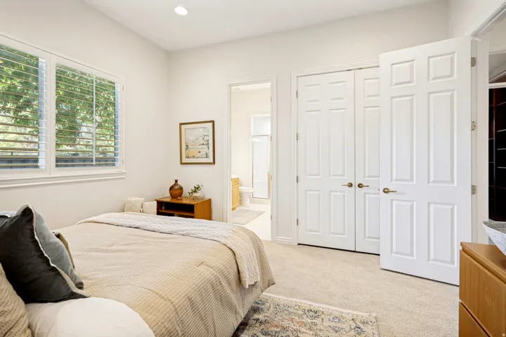 Second bedroom with light beige carpeting and white walls