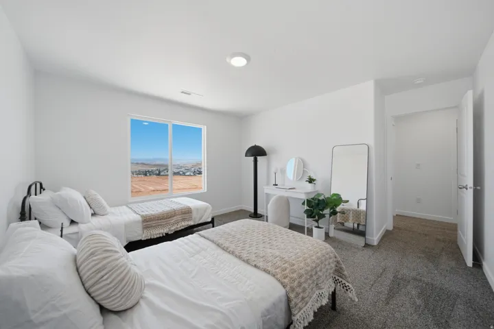 Bright interior with a large window, neutral wall paint, recessed lighting, and carpeted flooring