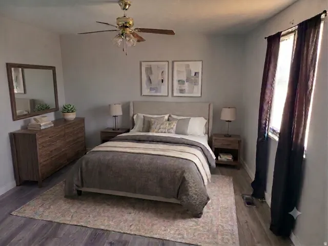 Wood-finish flooring with light gray walls and a ceiling fan