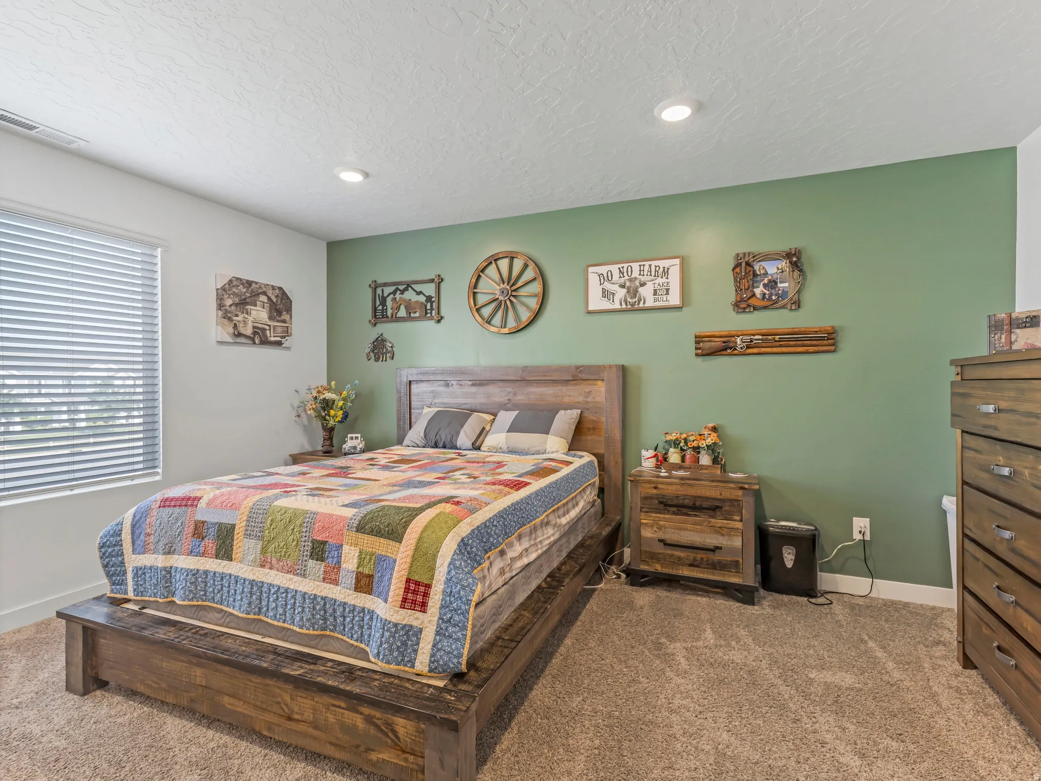 Carpeted room featuring a window with horizontal blinds, a recessed ceiling light, and a two-tone painted wall