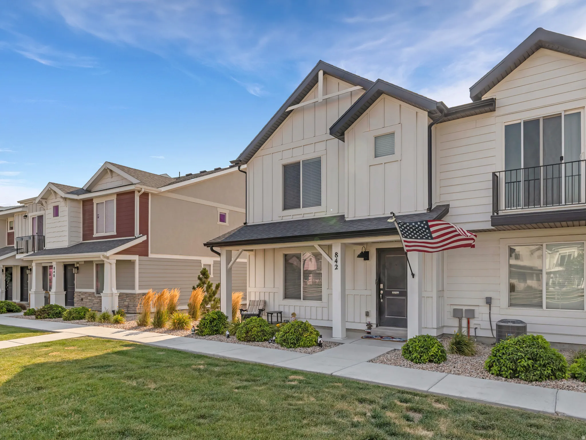 Modern townhome exterior featuring vertical and horizontal siding