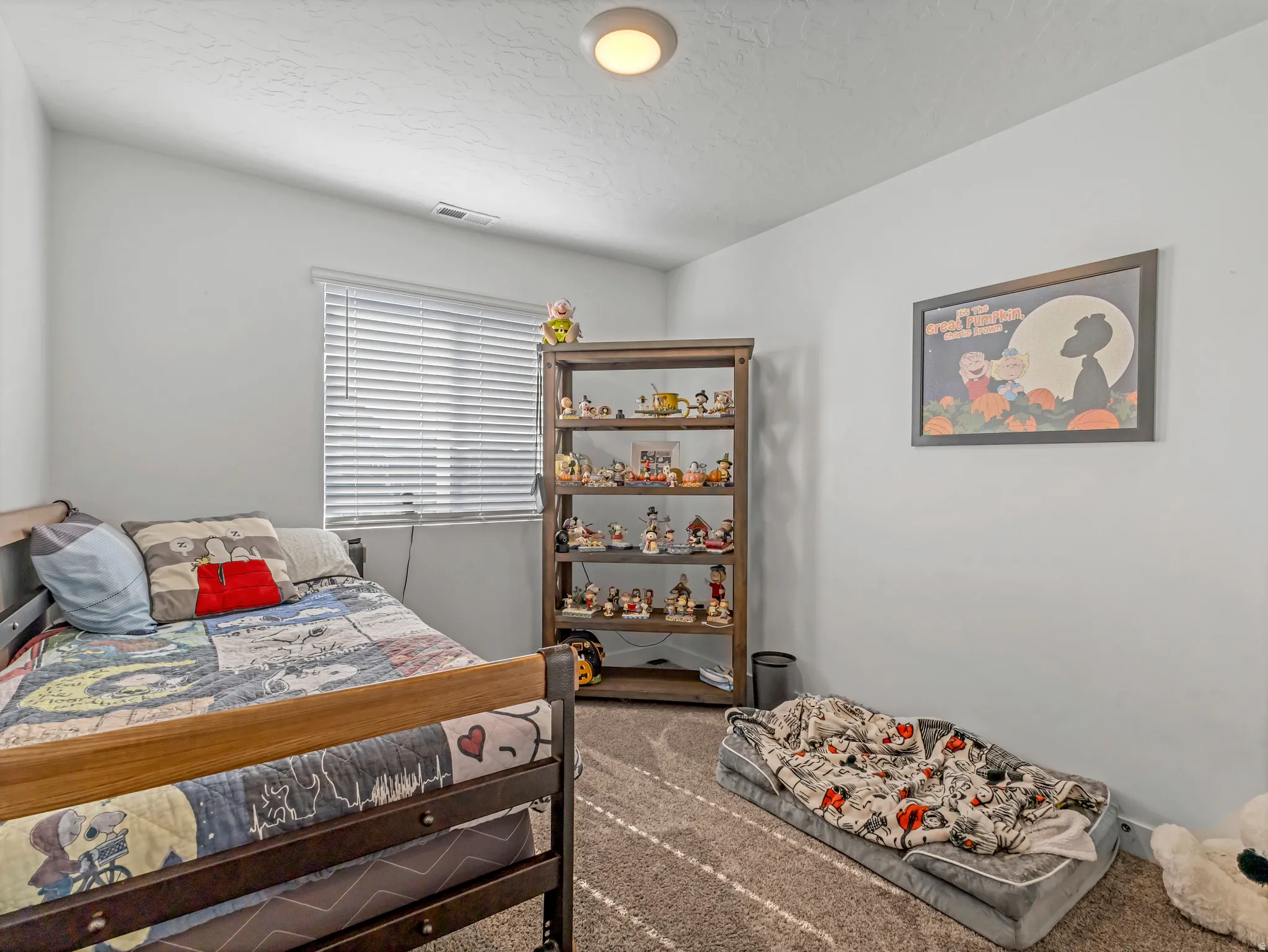 Neutral wall color with a window featuring blinds
