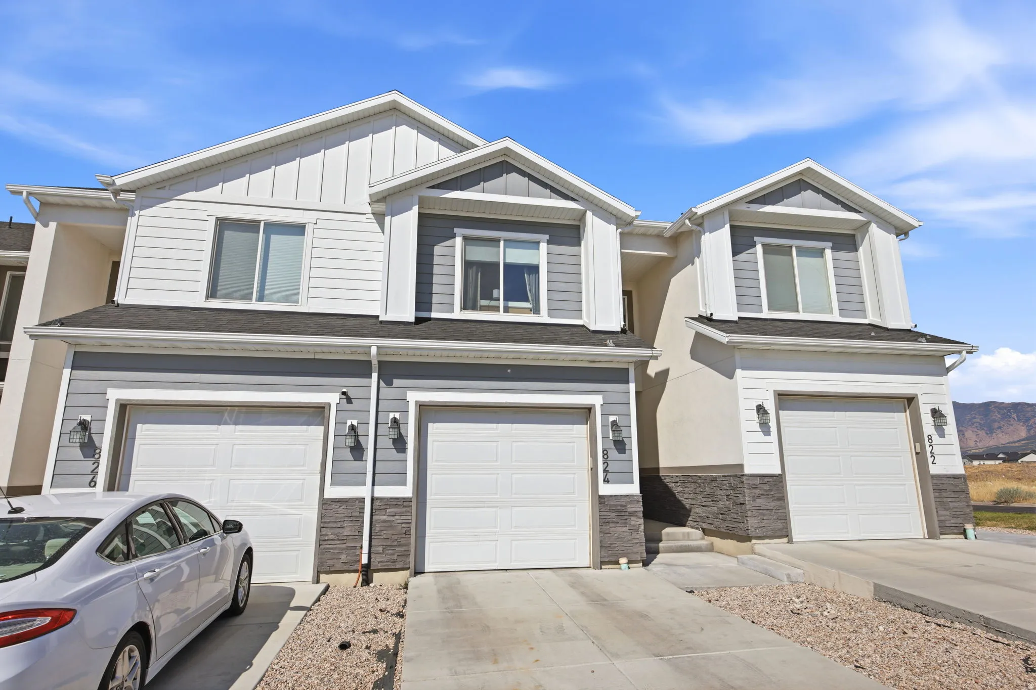 Modern townhome community featuring three distinctive units with two-story architectural designs