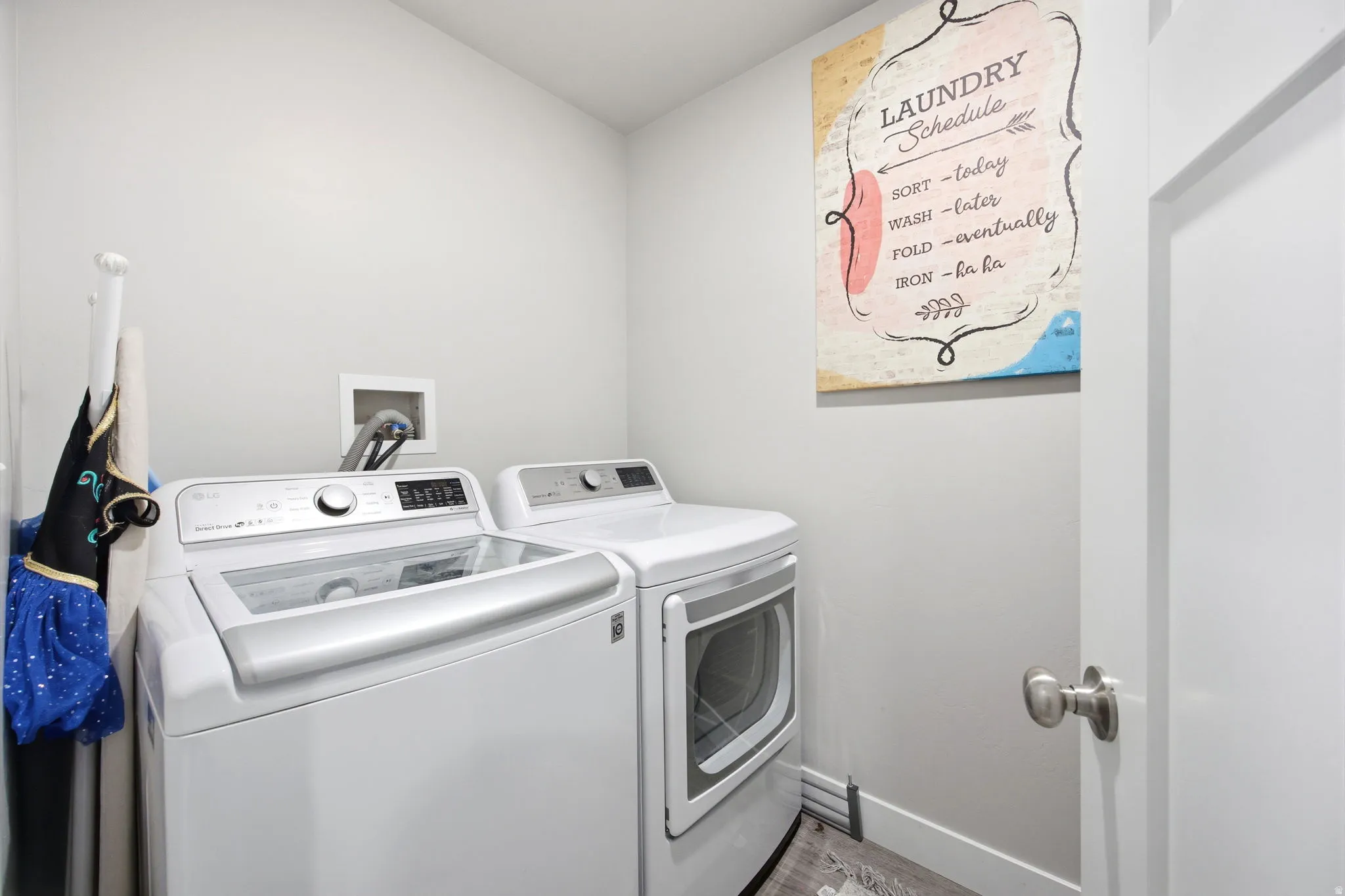 Dedicated laundry room featuring side-by-side top-load washer and front-load dryer with white finish