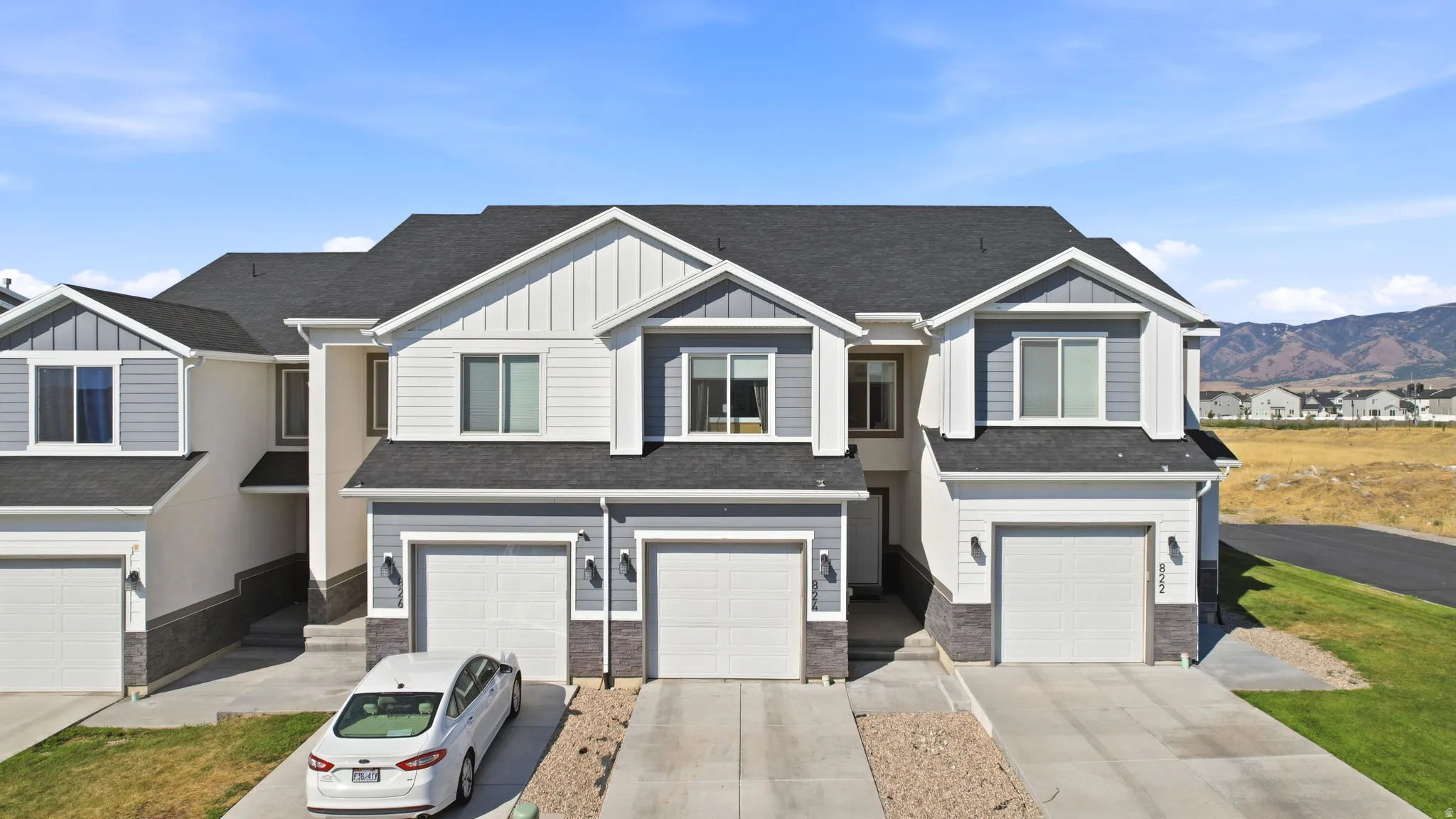 Modern townhome community featuring clean-lined architectural design with peaked rooflines and gabled details