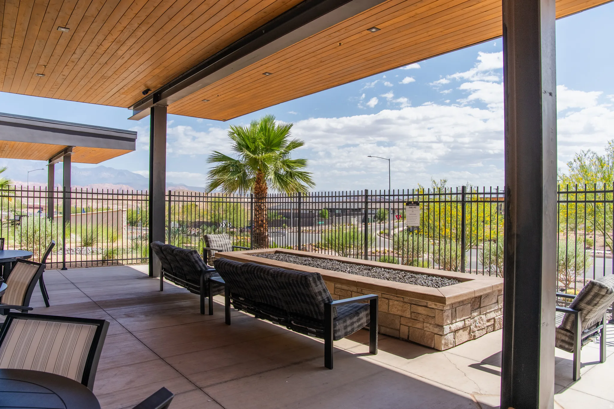 Covered patio featuring a wood-finish ceiling, exposed structural beams, and recessed lighting