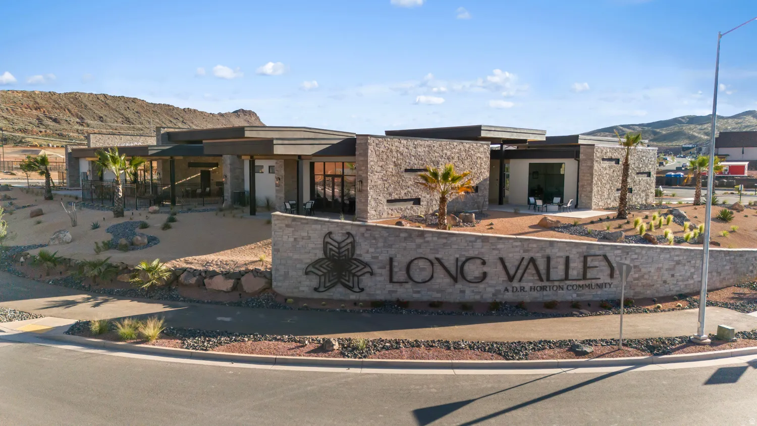 Stone-clad entry monument featuring a modern community logo