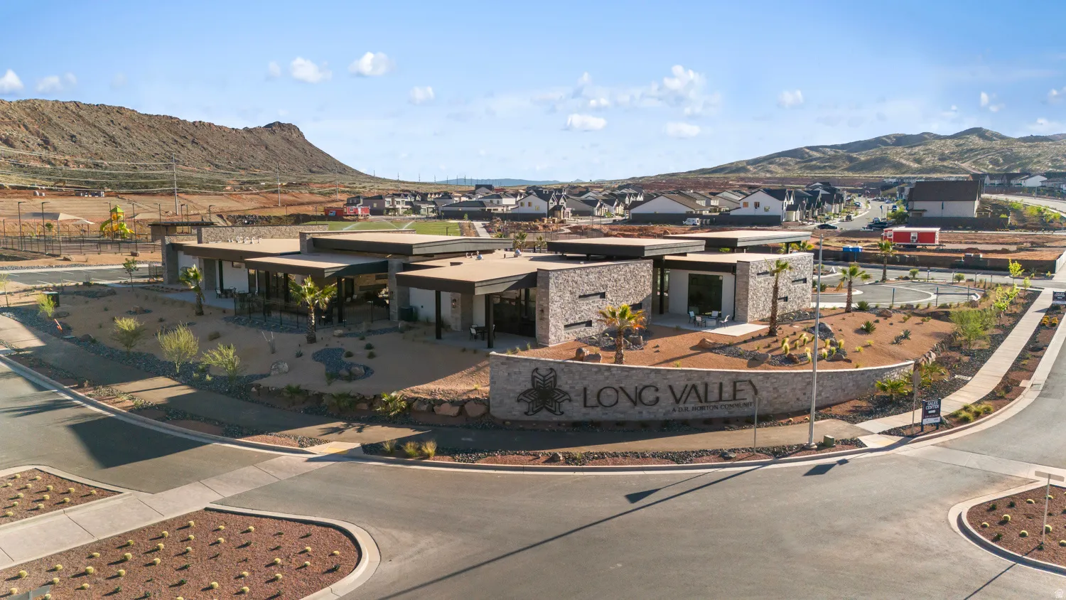 Modern community building featuring stone-clad walls, flat rooflines, and expansive windows