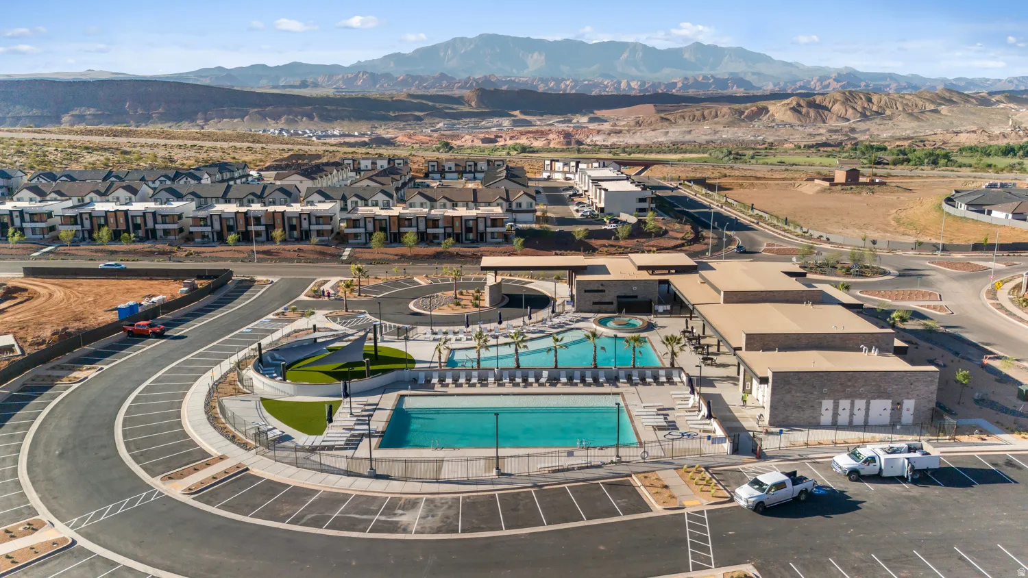 Community amenities featuring two swimming pools, a central clubhouse building, dedicated lounge areas, and surrounding manicured landscaping