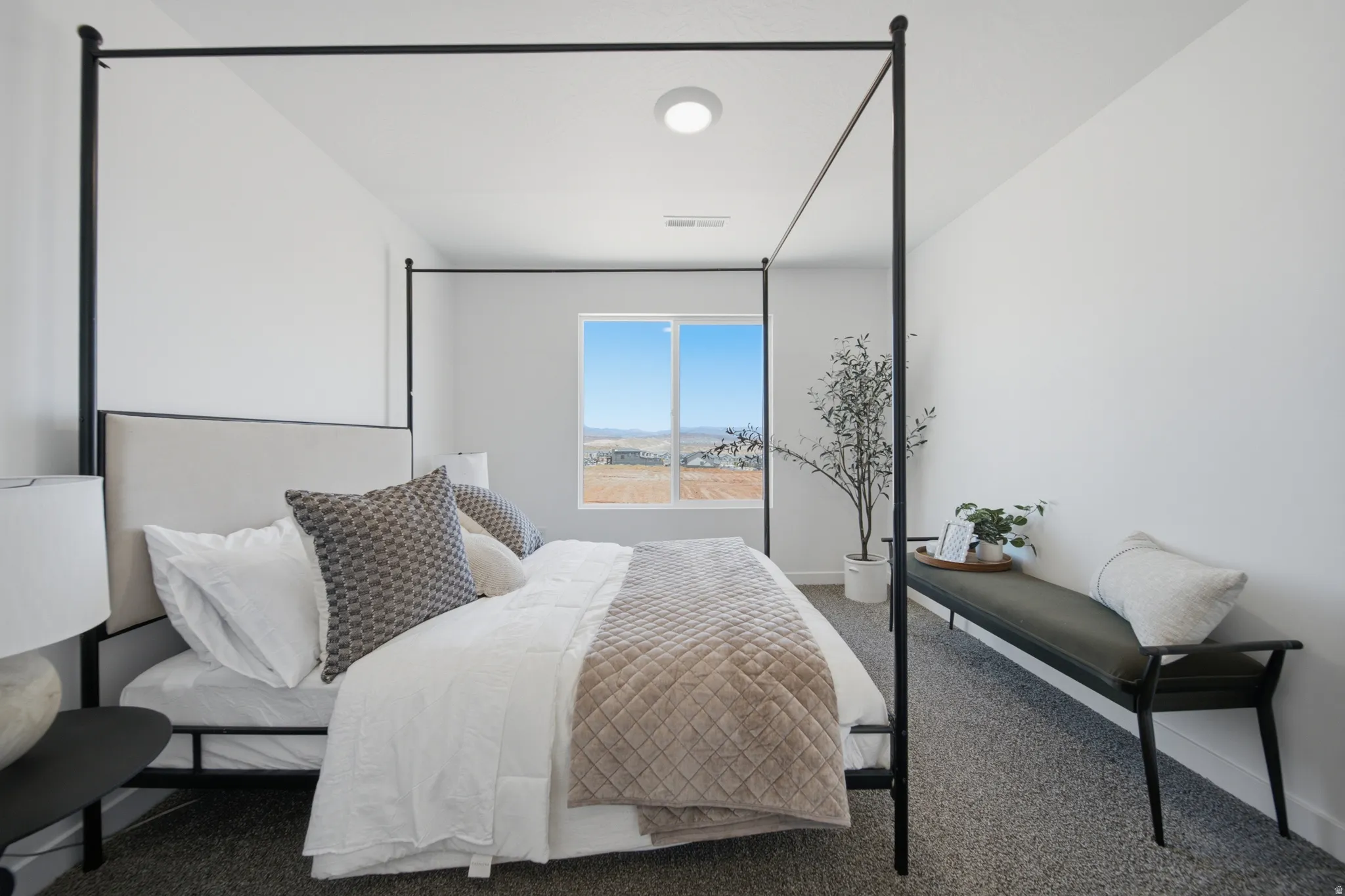 Spacious room featuring white walls, a large window, recessed lighting, and textured carpeting