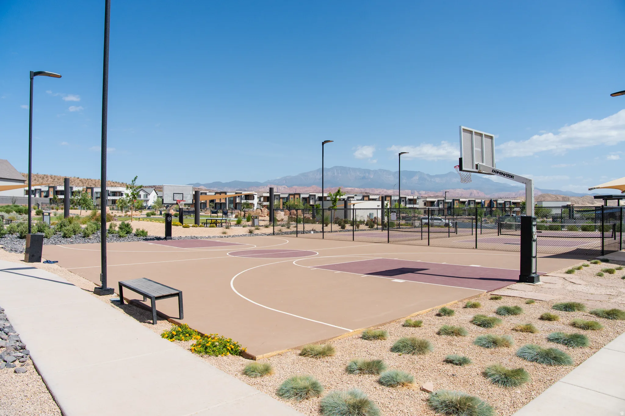Outdoor sports court featuring basketball hoops and multiple playing areas
