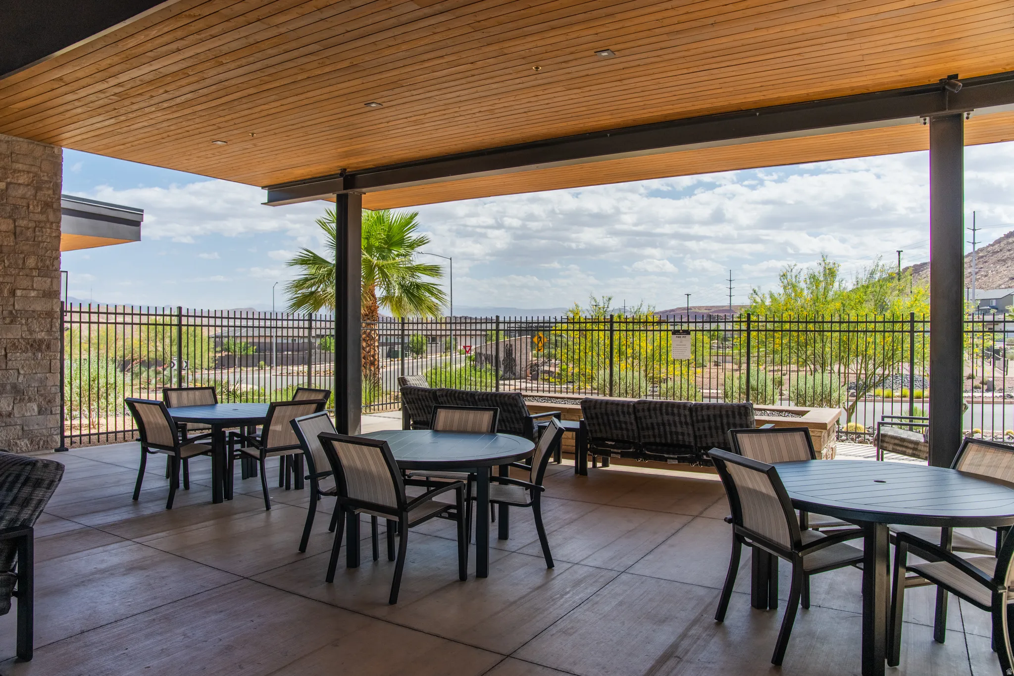 Covered outdoor patio with wood-finish ceiling and stone column
