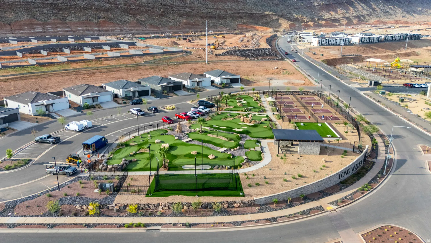 Community amenities featuring a miniature golf course, multiple pickleball courts, and artificial turf recreation areas