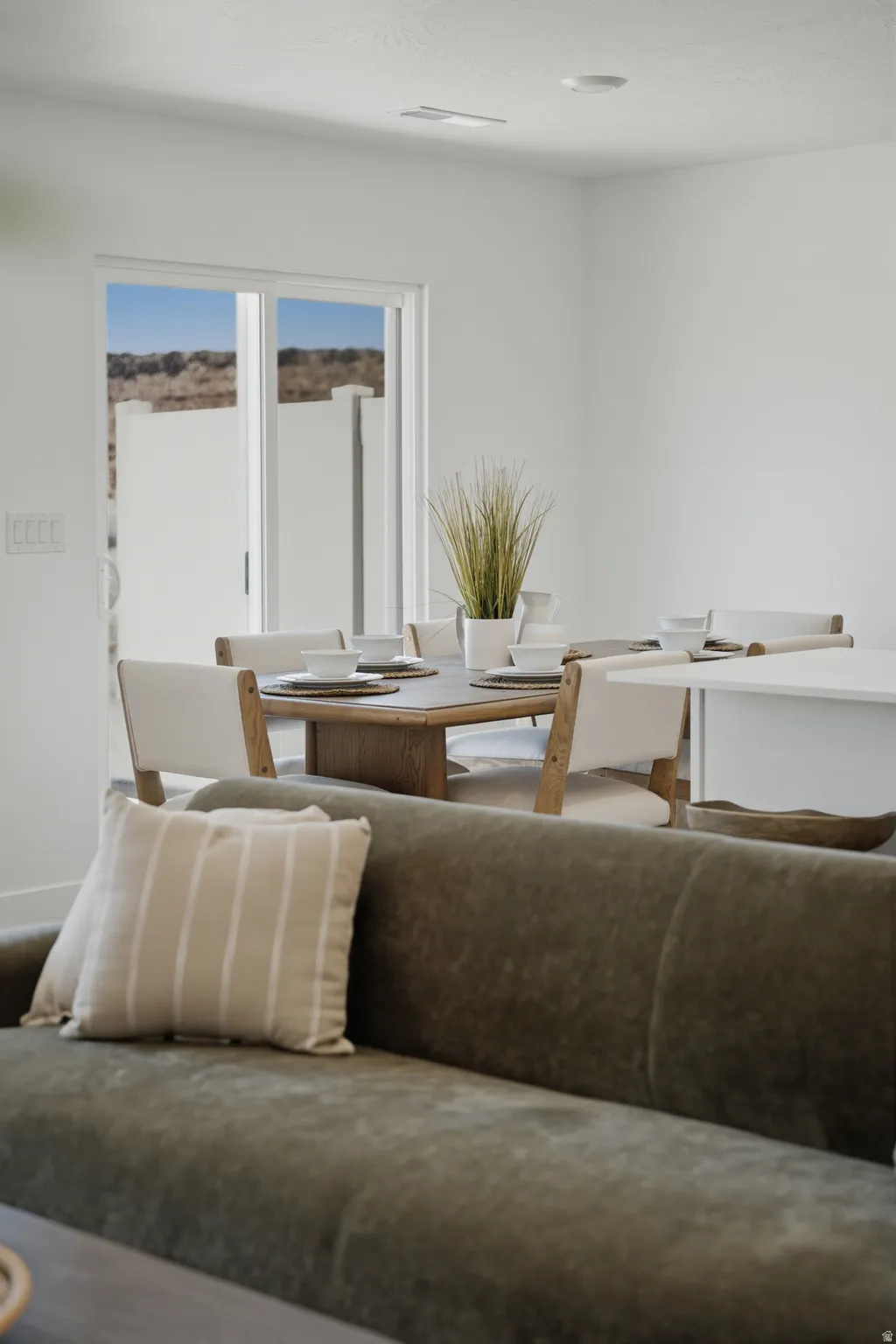Bright interior featuring a sliding glass door and white walls