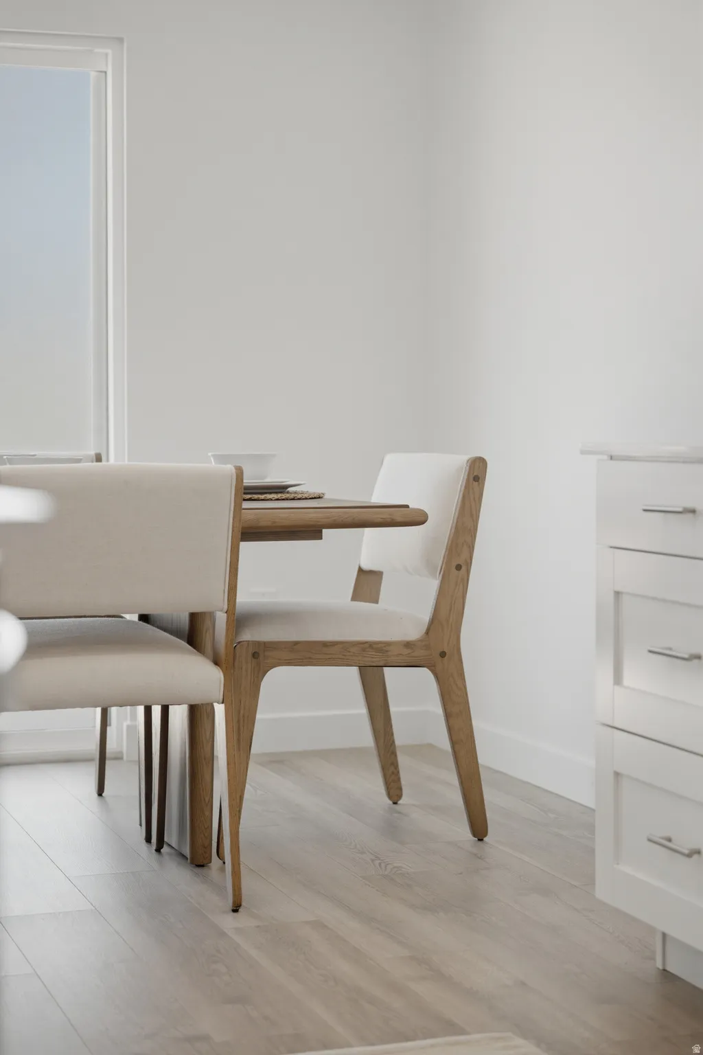 Light wood-finish flooring complements the crisp white walls
