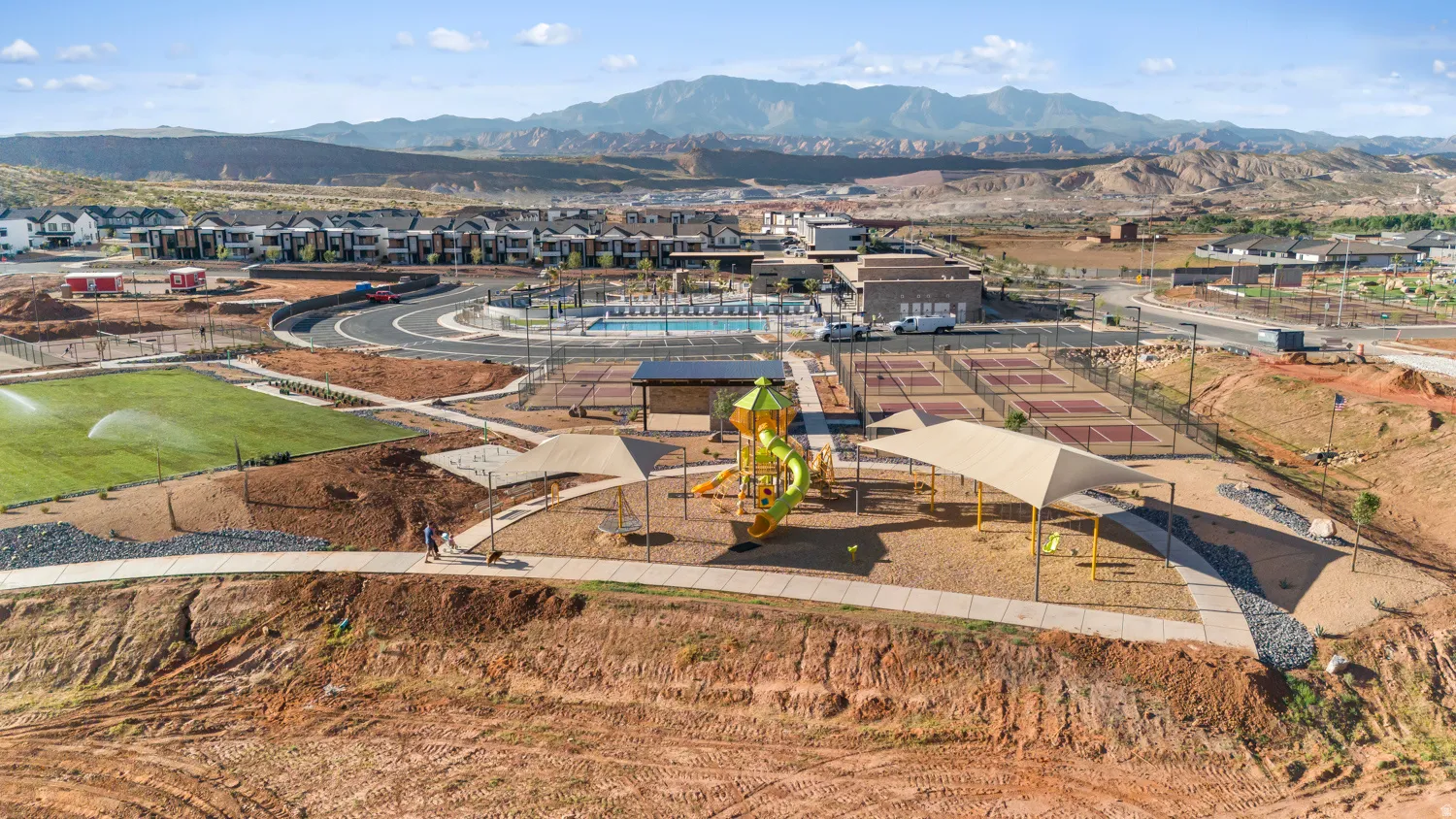 Aerial view showcasing expansive grounds with professional-grade sports facilities, including a regulation-size athletic field with synthetic turf, multiple clay courts, and dedicated training infrastructure